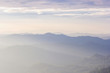 © kannapon - Beautiful view of the morning fog filling the valleys of smooth hills.