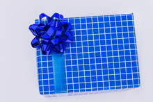 Beautifully Wrapped Blue Patterned Gift Box. Gift Box Packed In Blue Checkered Paper With Bow. Happy Fathers Day.