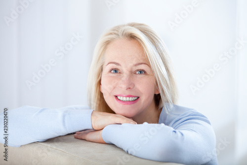 Active beautiful middle-aged woman smiling friendly and looking in camera Tableau sur Toile