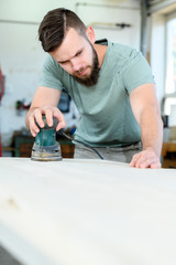 young worker in a carpenter's workshop