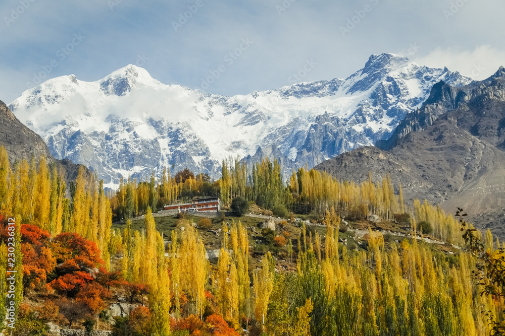 Autumn scene in Hunza valley with snow capped mountains in the ...