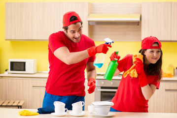 Cleaning professional contractors working at kitchen