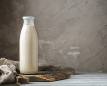 Fresh Milk In Glass Bottle On Rustic Background
