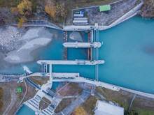 Aerial View Of River Dam In Small River In Switzerland In Evening Sunlight