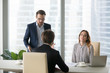 © fizkes - Dissatisfied man shouting at employee, trainee, blaming. Boss scolding subordinates for bad results in report. Executive director is dissatisfied with work of incompetent worker.