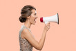 © yuriyzhuravov - Woman shouting into a megaphone. Pink background.