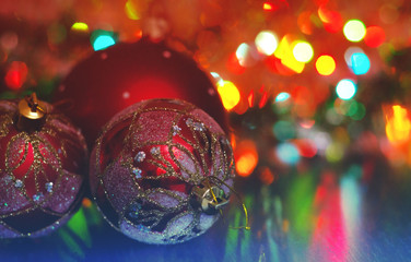 Wall Mural - christmas ball close-up on the background of the lights garland blurred purple and blue background