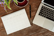 © stnazkul - SEPTEMBER 17, 2018: Working table top with organizer for monthly planing with a pen, macbook air and a cup of black coffee