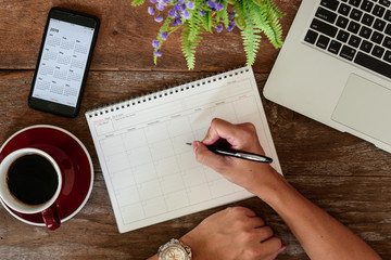 september 17, 2018: working table top with organizer for monthly planing with iphone 8 plus use cale