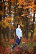 © Master Video - Girl in a yellow autumn forest. Beautiful young woman walks along the path of the autumn forest.