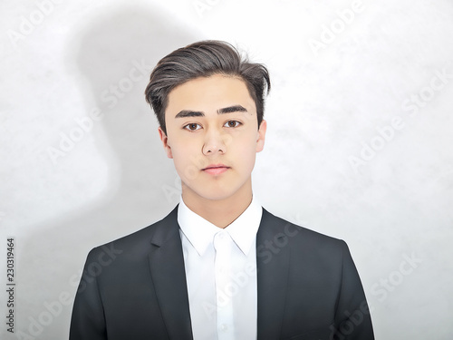 Young European Asian Man Wearing A Black And White Suit