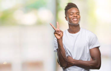 Young african american man over isolated background smiling with happy face winking at the camera doing victory sign. Number two.