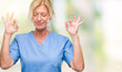 © Krakenimages.com - Middle age blonde woman wearing doctor nurse uniform over isolated background relax and smiling with eyes closed doing meditation gesture with fingers. Yoga concept.