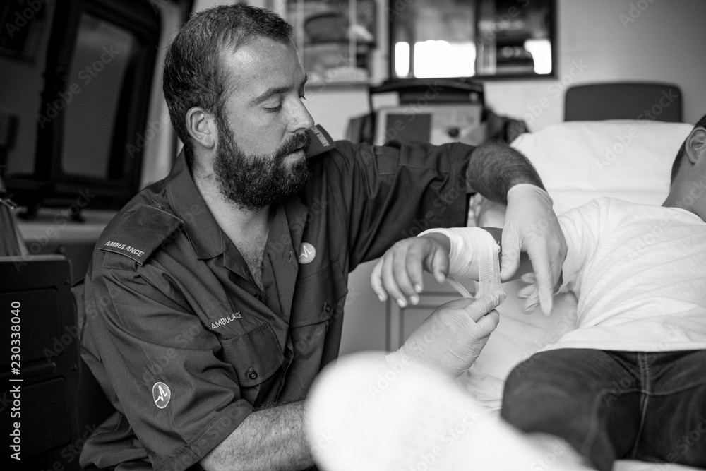 Paramedic giving a first aid to a young boy in an ambulance Stock Photo ...