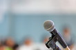 © Akarawut - Standing microphone for speaker's speech in the seminar room with audience in the background