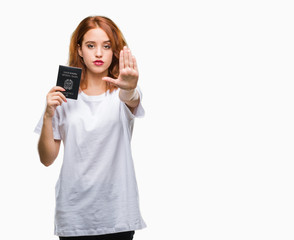 Wall Mural - Young beautiful woman holding passport of italy over isolated background with open hand doing stop sign with serious and confident expression, defense gesture