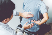 Doctor Consulting With Patient Back Problems Physical Therapy Concept