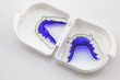 Blue Acrylic dental retainer isolated in white box on white