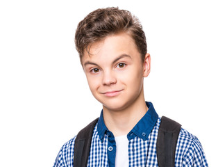 Wall Mural - Close up emotional portrait of caucasian teen boy. Portrait of handsome smiling guy. Funny cut teenager, isolated on white background. Child looking at camera.