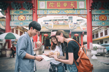 Traveler are discussing about theirs trip at the front of Kuan Yim Shrine ( chinese text) Chinese Temple in Thailand