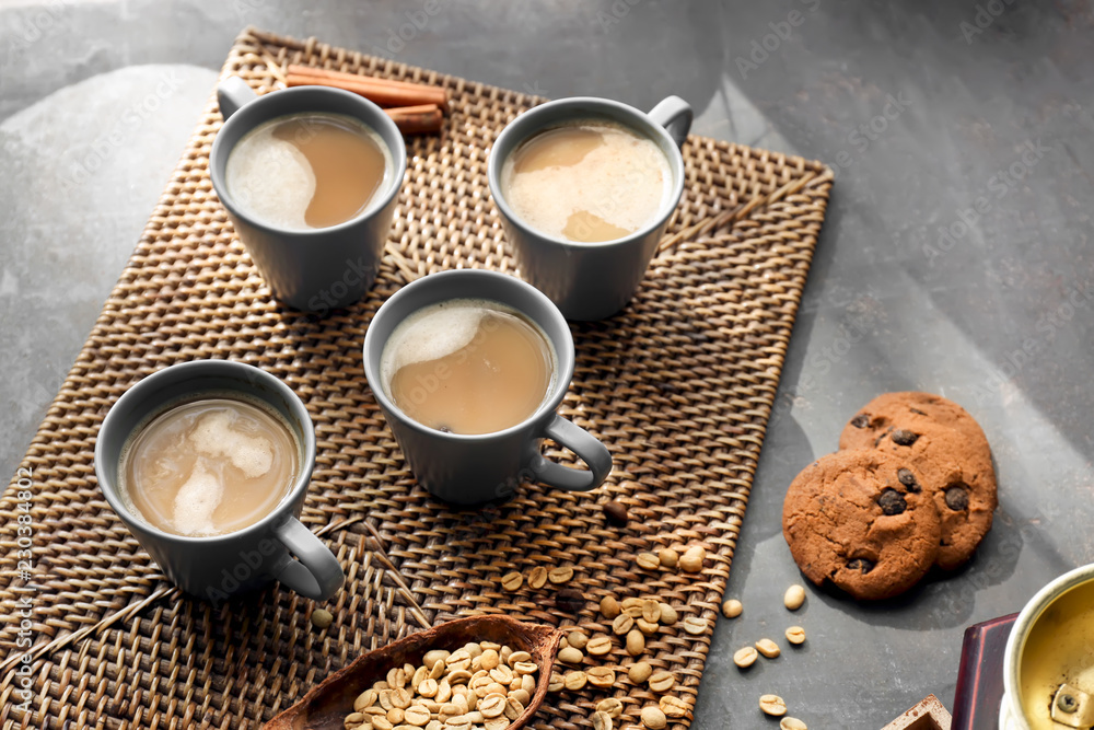 Cups with tasty aromatic coffee and cookies on table