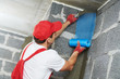 © Kadmy - plasterer worker protecting corner with mesh. building technology