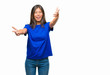 © Krakenimages.com - Young asian woman over isolated background looking at the camera smiling with open arms for hug. Cheerful expression embracing happiness.