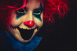Creepy clown close up halloween portrait on black background