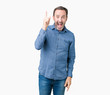 © Krakenimages.com - Handsome middle age elegant senior man over isolated background pointing finger up with successful idea. Exited and happy. Number one.