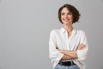 happy young business woman posing isolated over grey wall background.