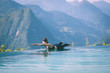 © 220 Selfmade studio - Beautiful Attractive Asian woman practice yoga Locust or Shalabhasana pose on the pool above the Mountain peak in the morning in front of beautiful nature views in SAPA vietnam