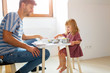 © pikselstock - Father and daughter having a tea party at home
