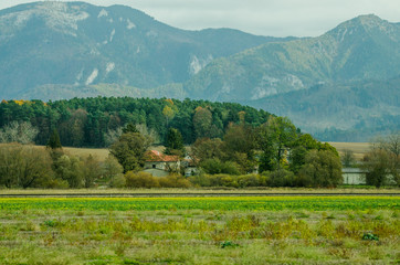 Wall Mural - Ladnscape from Slovakia - green meadows and fields in the background the mountains