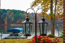 Lanterns Hanging In Front Of Fall Colors Around The Lake