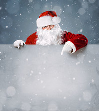 Santa Claus Pointing On Blank Advertisement Banner With Copy Space