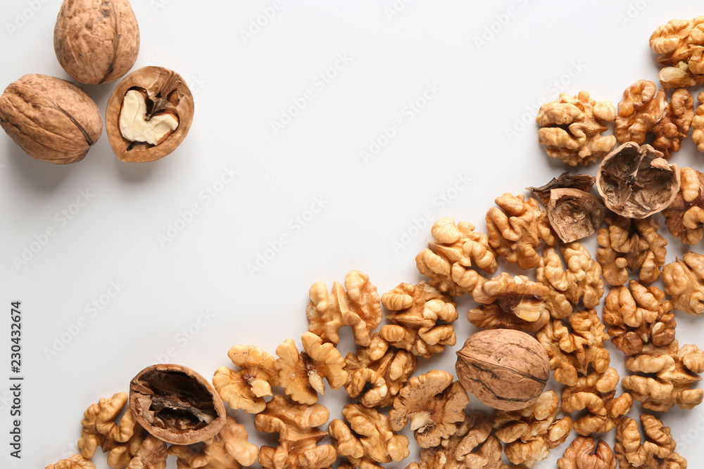 Tasty walnuts with shell on white background