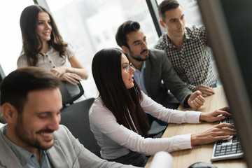 Young businesspeople working on computer in office