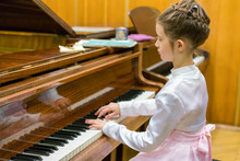 Little Girl Playing The Grand Piano
