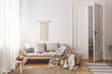 Wall Mural - Living room with stylish macrame, sofa, wooden accessories and doors open to next room