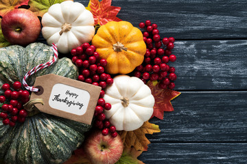 Wall Mural - top view of autumn maple leaves with pumpkin and red berries on old wooden backgound. thanksgiving d