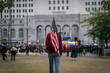 © Elijah Hurwitz - A young man carries an American flag to a protest