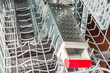 © Evgenii - Iron grater with a red handle lies in the dishwasher