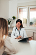 © bnenin - Female doctor and female patient talking about test results.