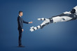 © gearstd - A tiny businessman stands in a side view and lifts his hand to touch a giant robotic arm.