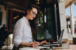 © Jacob Lund - Businesswoman working from a coffee shop