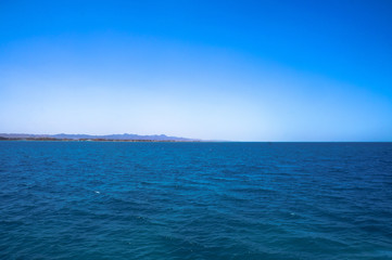  Beautiful blue sea surface with the sky. Oceanic deserted, lonely theme for background. Stock photo for tourist design