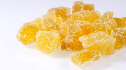 Wall Mural - Close up heap of crystallized candied ginger pieces on white.  Yummy snack, better alternative to candy