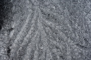 Closeup on hoarfrost on a black surface