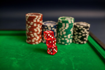 playing cards,dices and poker chips on green poker table