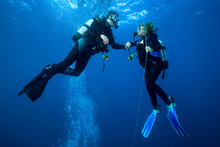Happy Couple Scuba Divers  Hovering Together On A Safety Stop